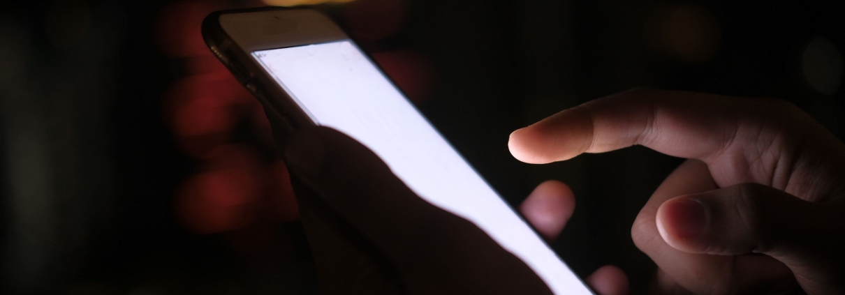 Spouse reading late-night text messages alone, wondering what they mean